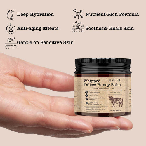 Hand holding a jar of 'Whipped Tallow Honey Balm' with product features listed on a beige background.